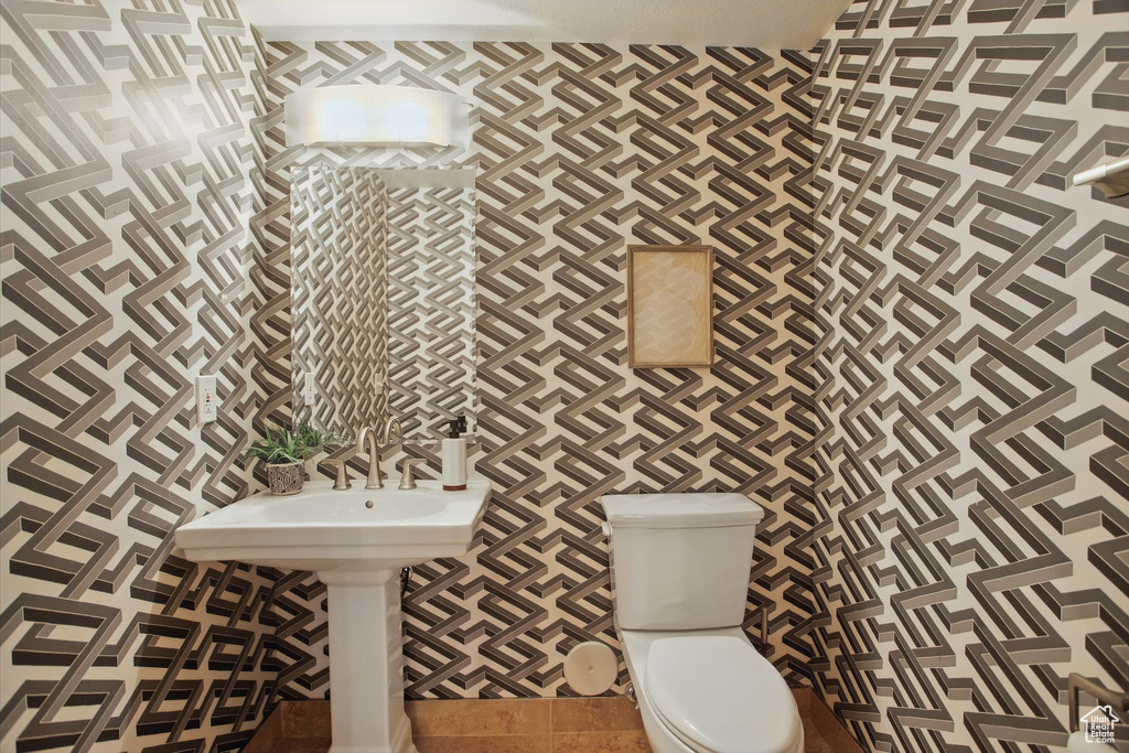 Bathroom with toilet and tile patterned floors