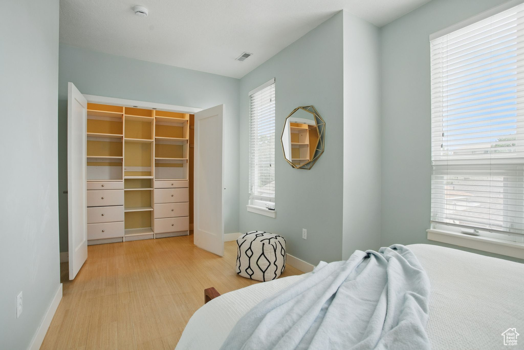 Bedroom with baseboards and light wood finished floors