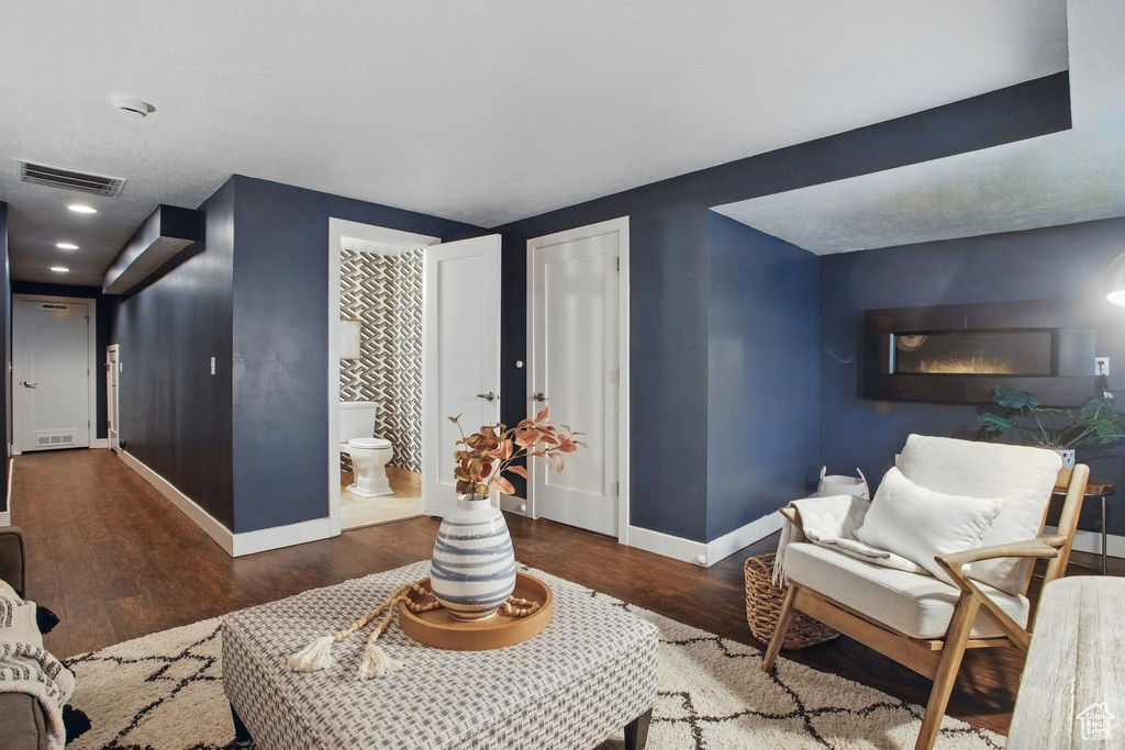 Living area with baseboards and wood finished floors