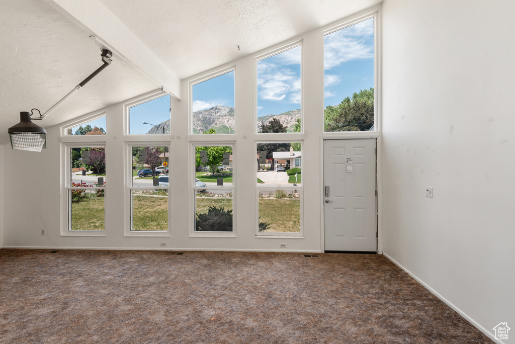 Unfurnished sunroom with healthy amount of natural light