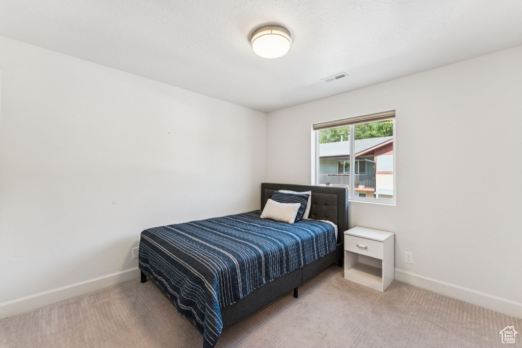 Carpeted bedroom with baseboards