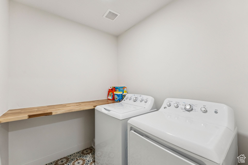 Laundry room with washing machine and dryer and baseboards