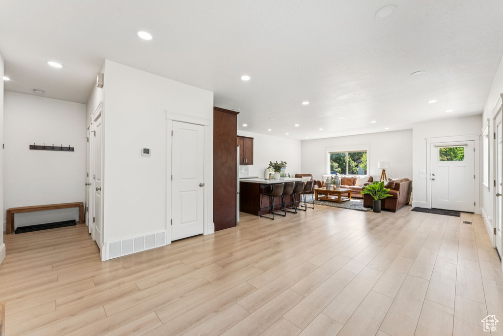 Foyer entrance featuring light wood-type flooring, recessed lighting, and baseboards