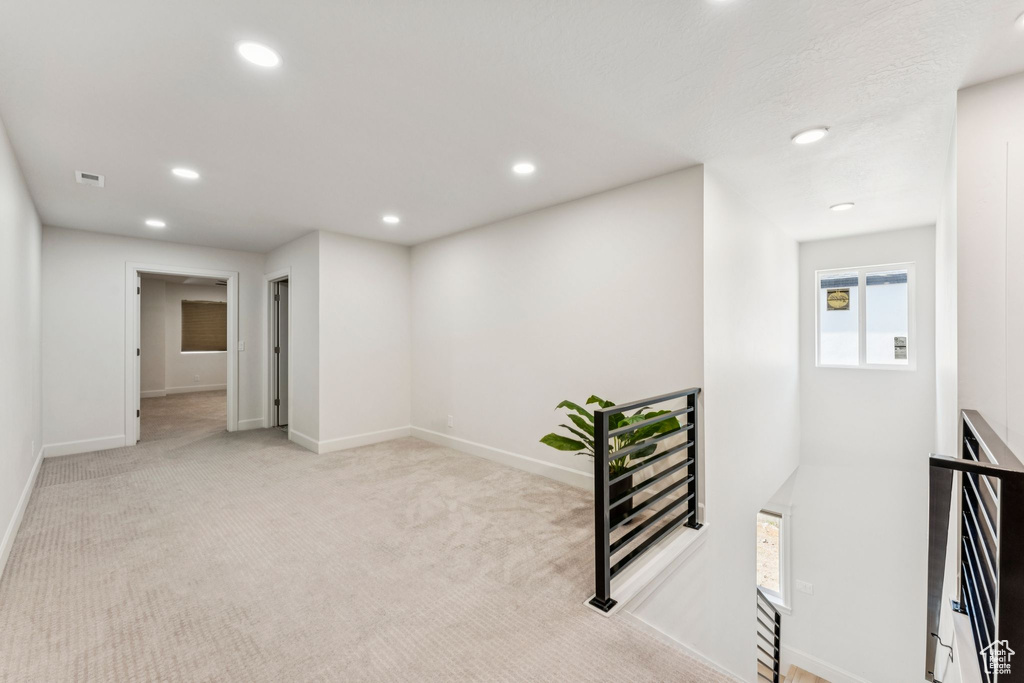 Hallway featuring an upstairs landing, recessed lighting, baseboards, and carpet