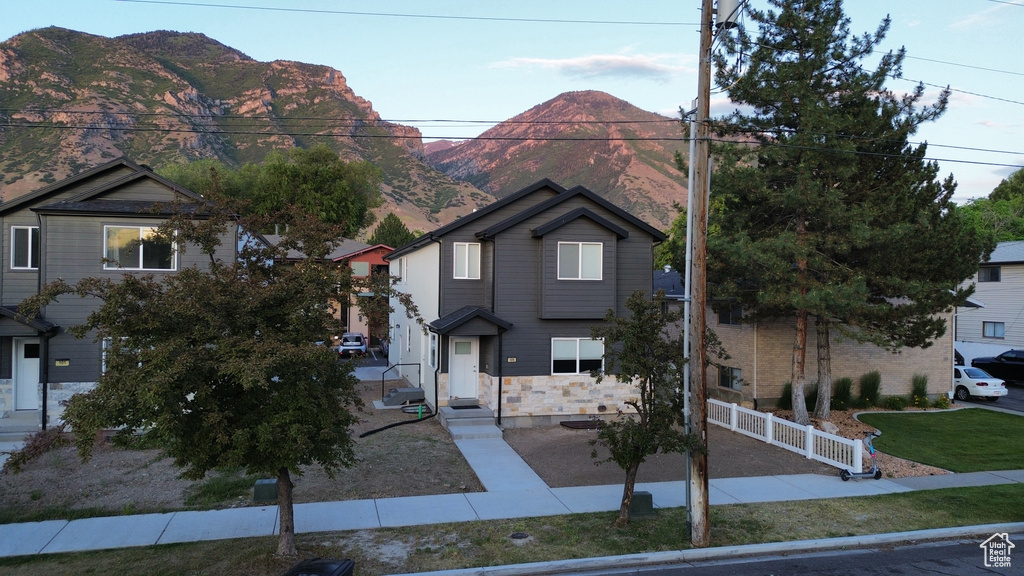 View of front of home featuring a mountain view and stone siding