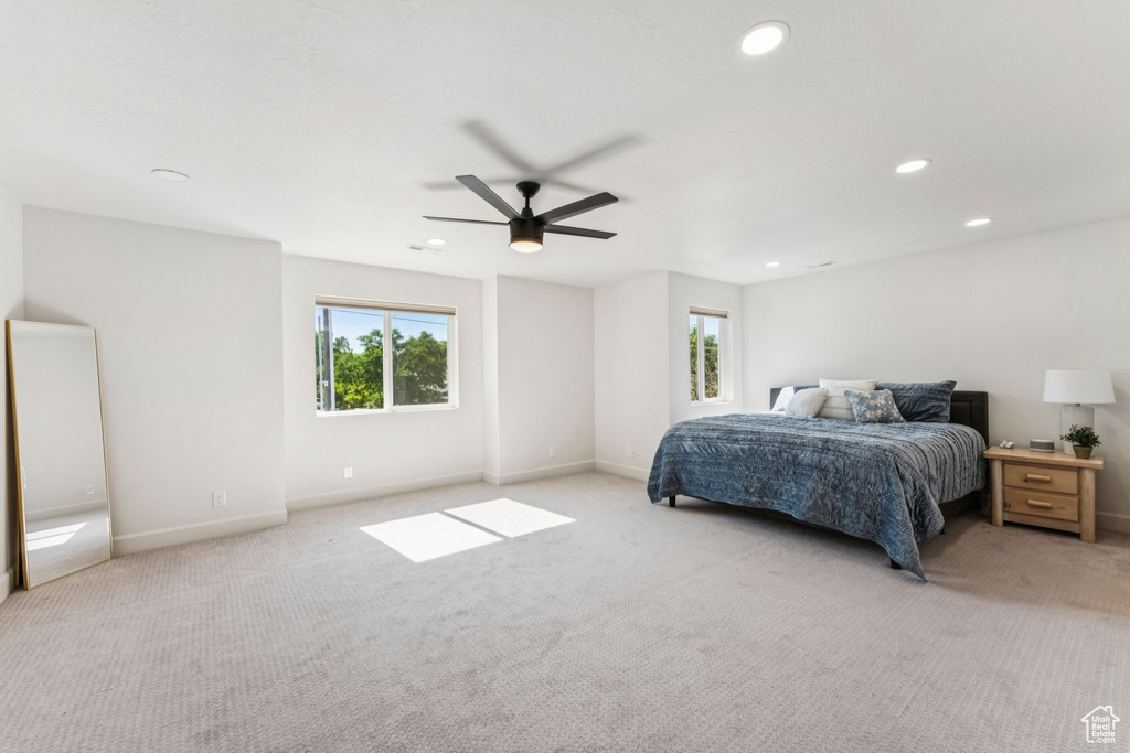 Bedroom with light colored carpet, baseboards, recessed lighting, and a ceiling fan
