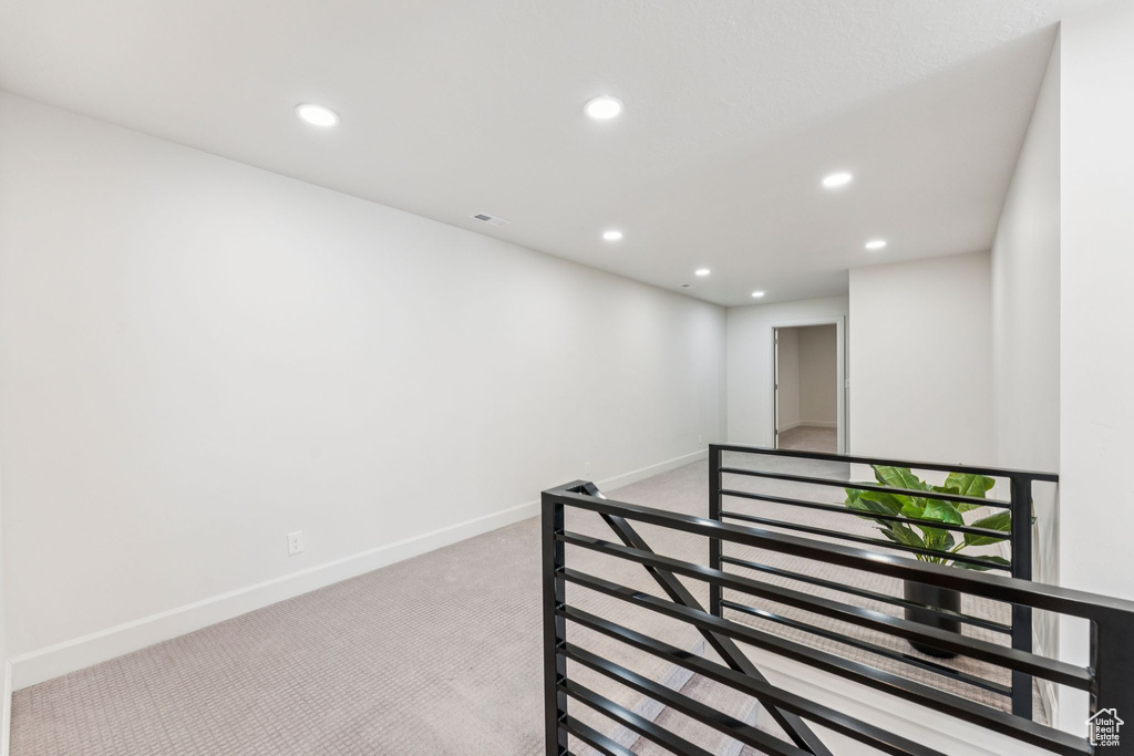 Hall with carpet floors, recessed lighting, and baseboards