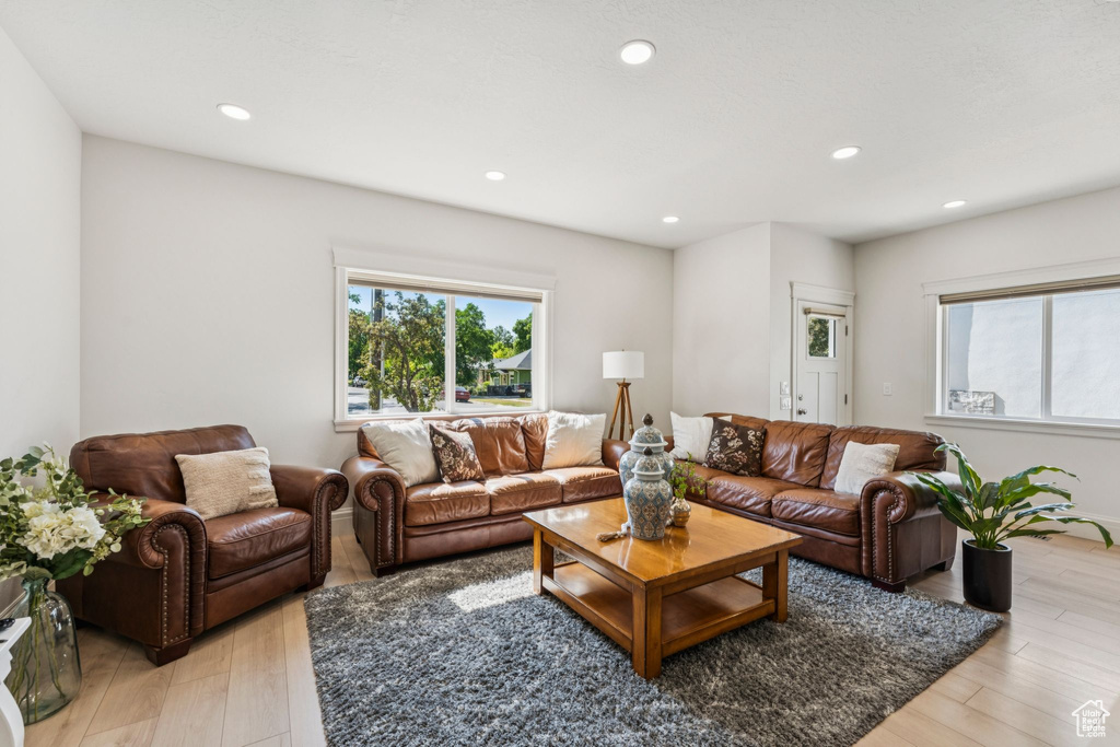 Living area with recessed lighting and light wood-type flooring