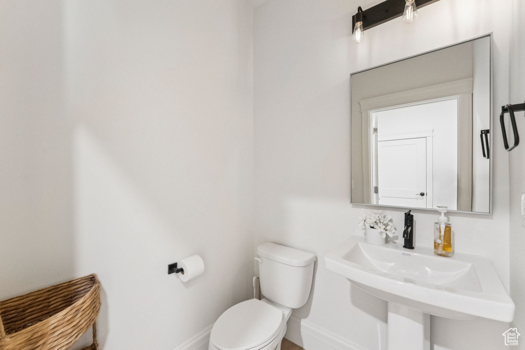 Bathroom featuring toilet and baseboards