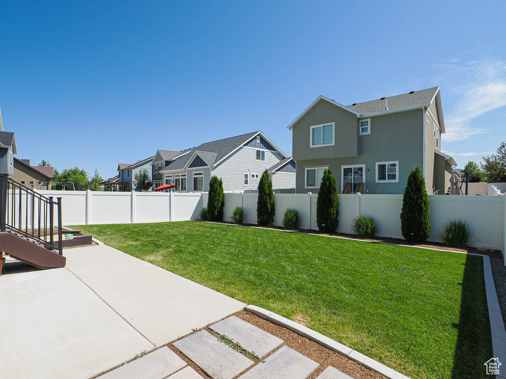 View of yard with a patio and a residential view