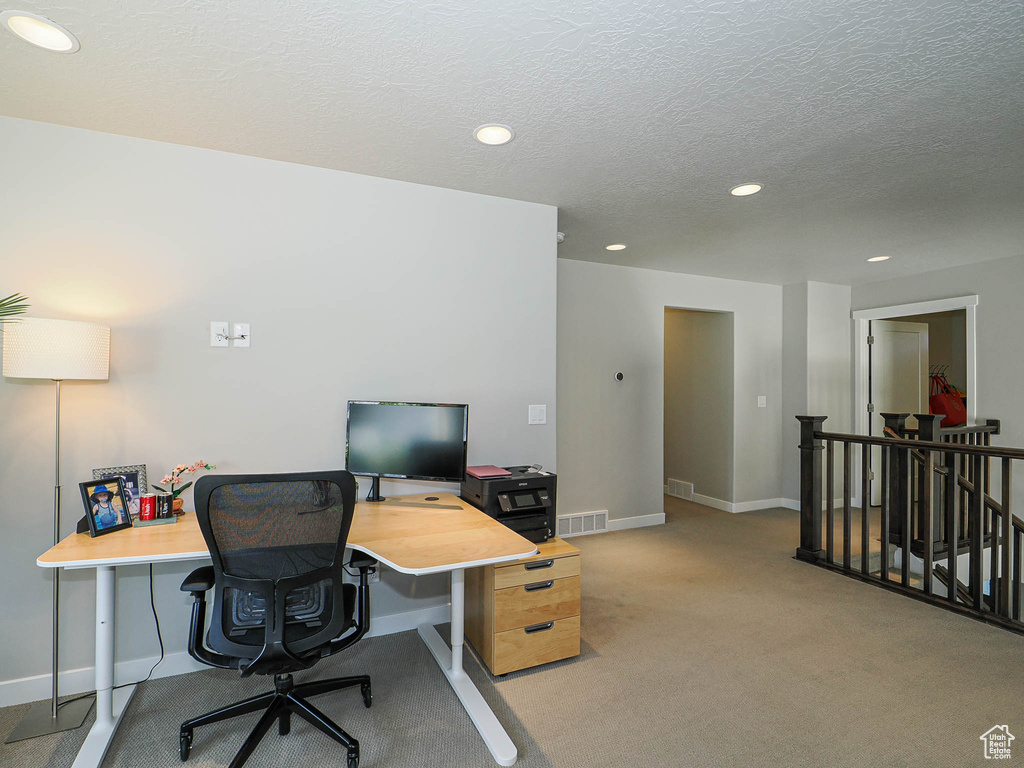 Carpeted office space with baseboards, recessed lighting, and a textured ceiling