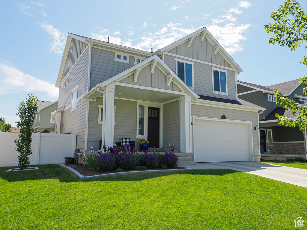Craftsman inspired home with board and batten siding, covered porch, concrete driveway, and a garage