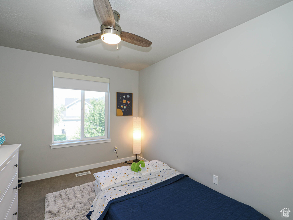 Bedroom with baseboards, carpet floors, and ceiling fan