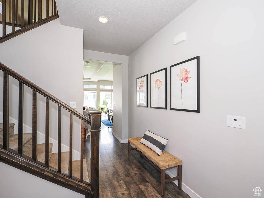 Stairs with wood finished floors, baseboards, and recessed lighting