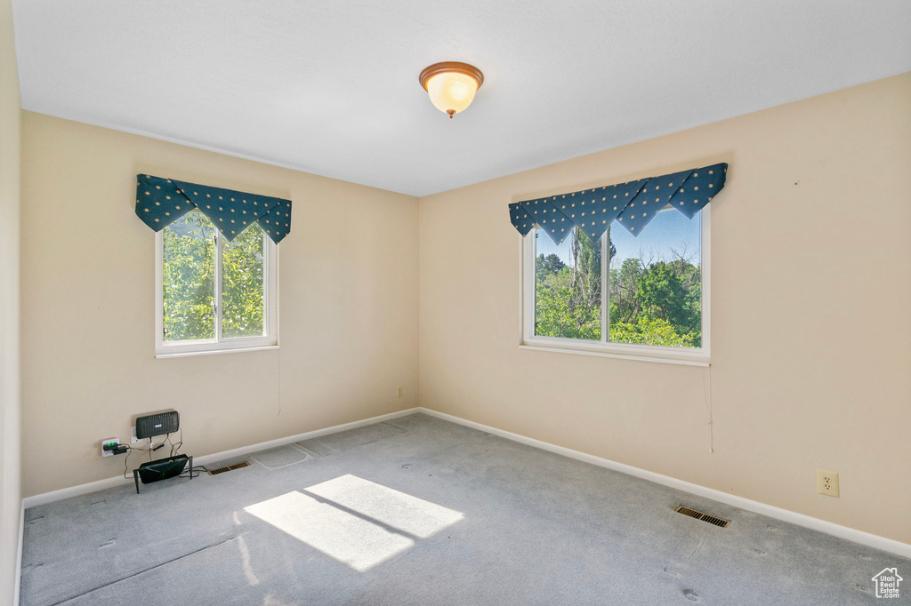 Empty room with carpet floors and baseboards