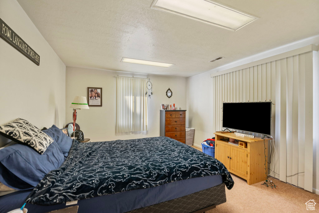 Carpeted bedroom with attic access