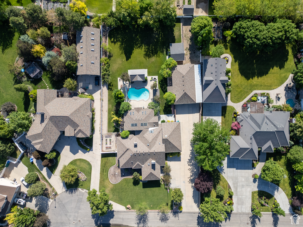 Aerial view of property and surrounding area featuring a pool