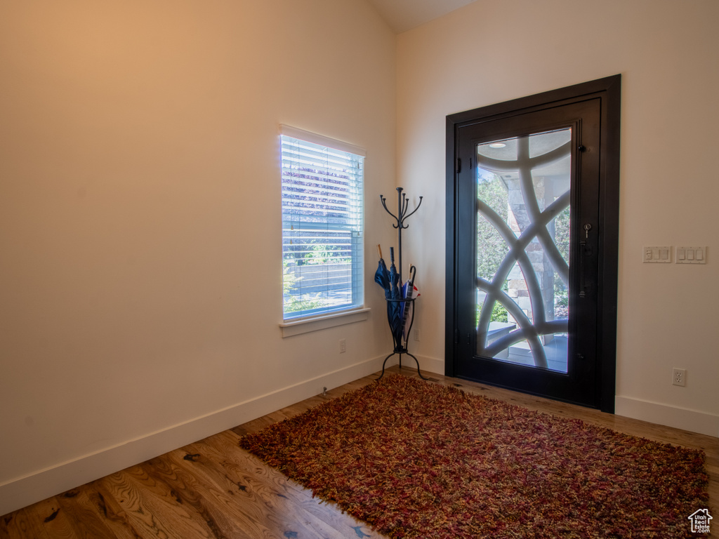 Foyer entrance featuring baseboards and wood finished floors