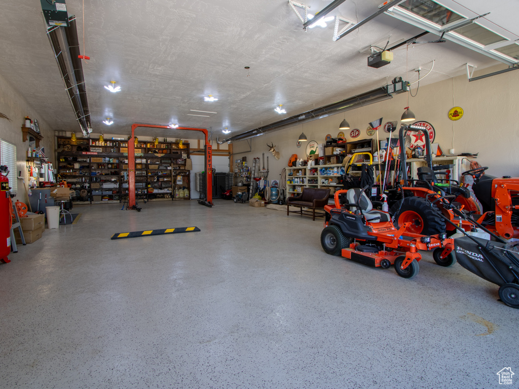 Garage with a workshop area and a garage door opener