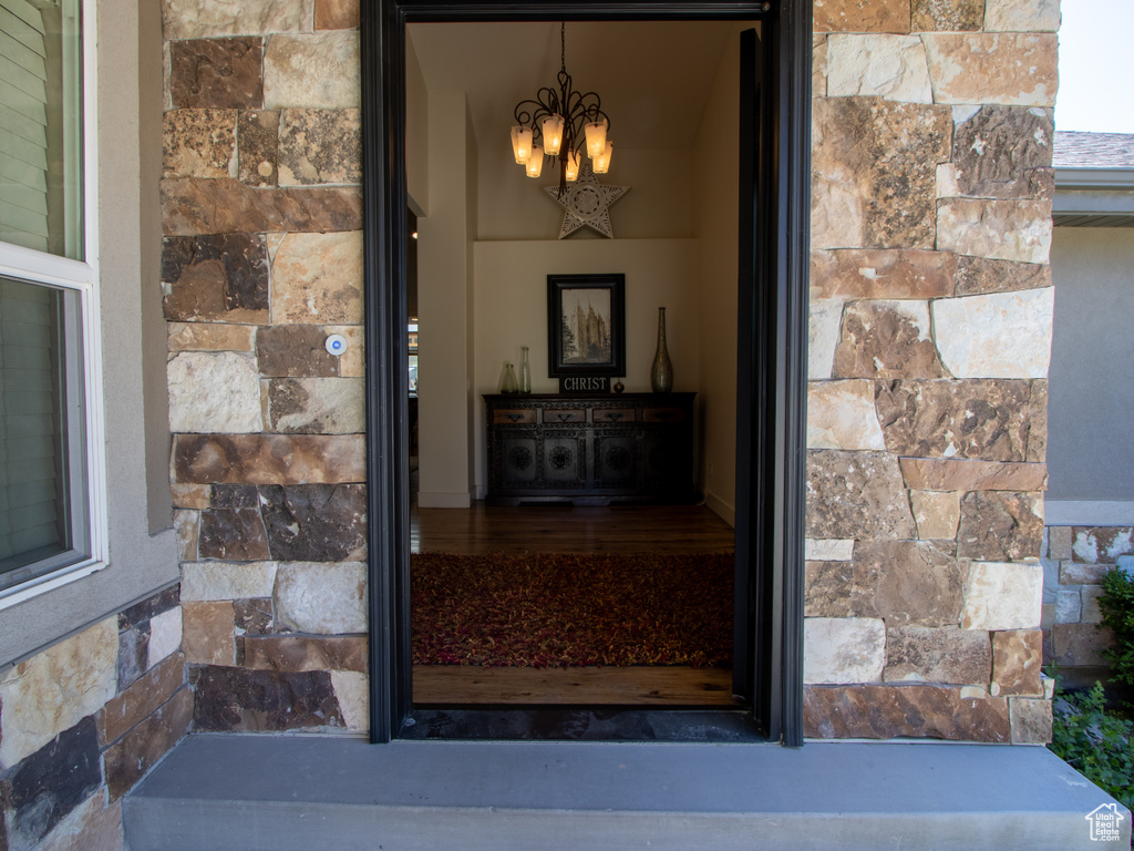 Entrance to property featuring stone siding