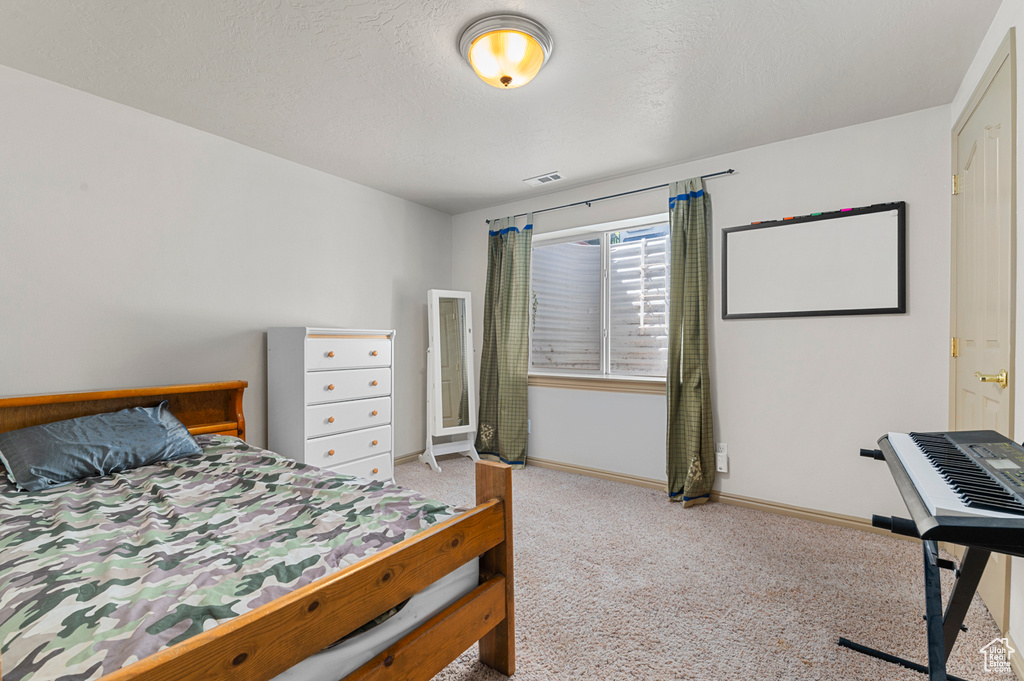 Bedroom featuring carpet floors and baseboards