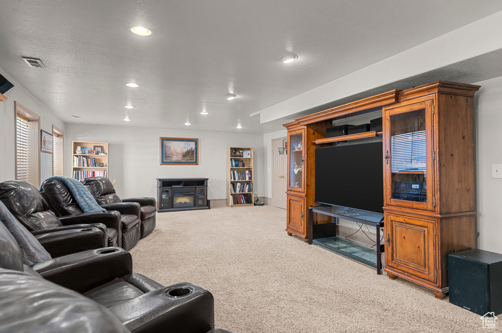 Carpeted living room featuring recessed lighting