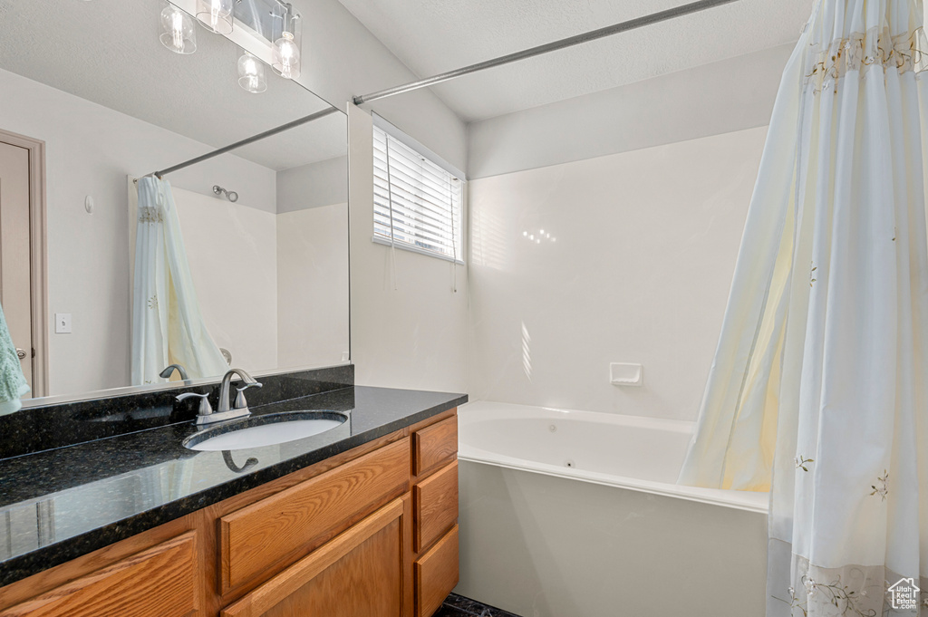 Full bathroom featuring vanity and shower / tub combo