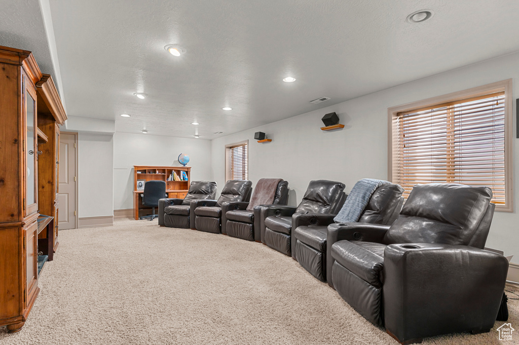 Carpeted home theater room featuring recessed lighting and baseboards