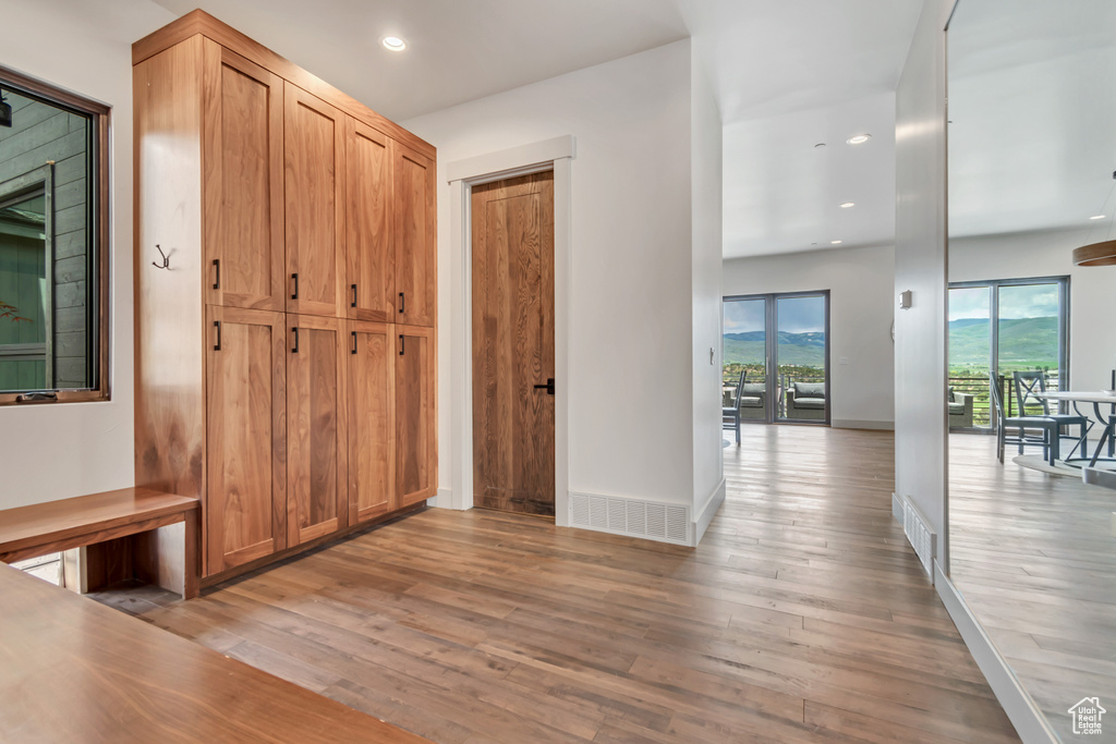 Hall featuring light wood-style floors, recessed lighting, and baseboards