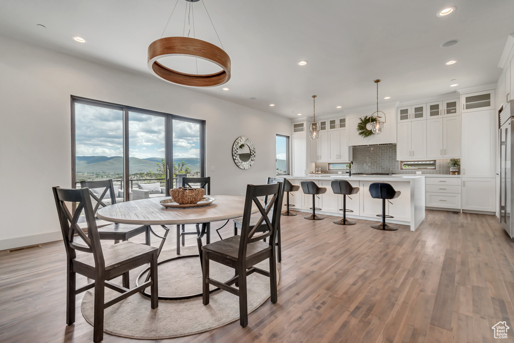 Dining area featuring recessed lighting, a mountain view, light wood finished floors, and baseboards