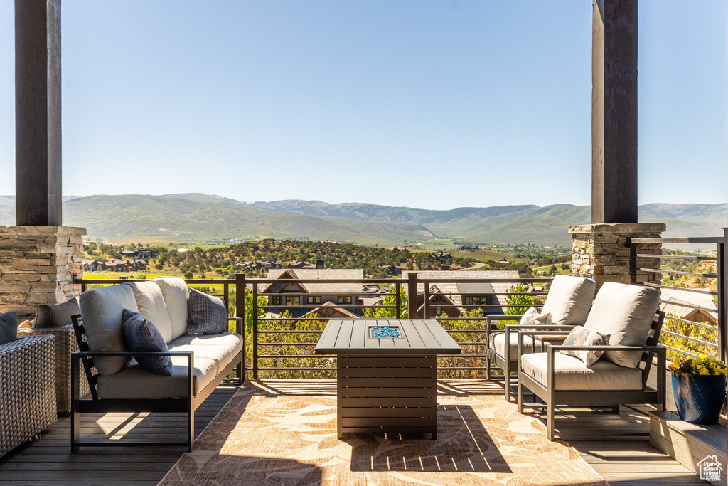View of patio / terrace with a mountain view, outdoor lounge area, and a balcony