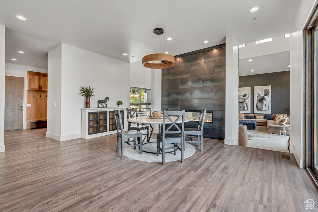 Dining area featuring wood finished floors, recessed lighting, and baseboards
