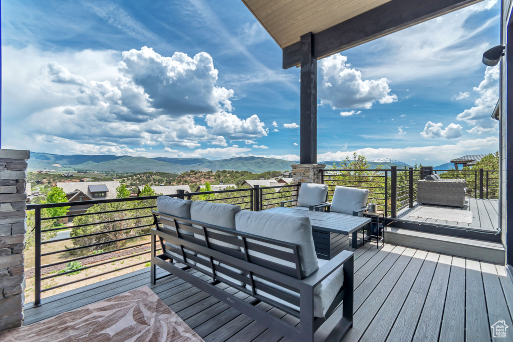 Wooden terrace with a mountain view and an outdoor living space