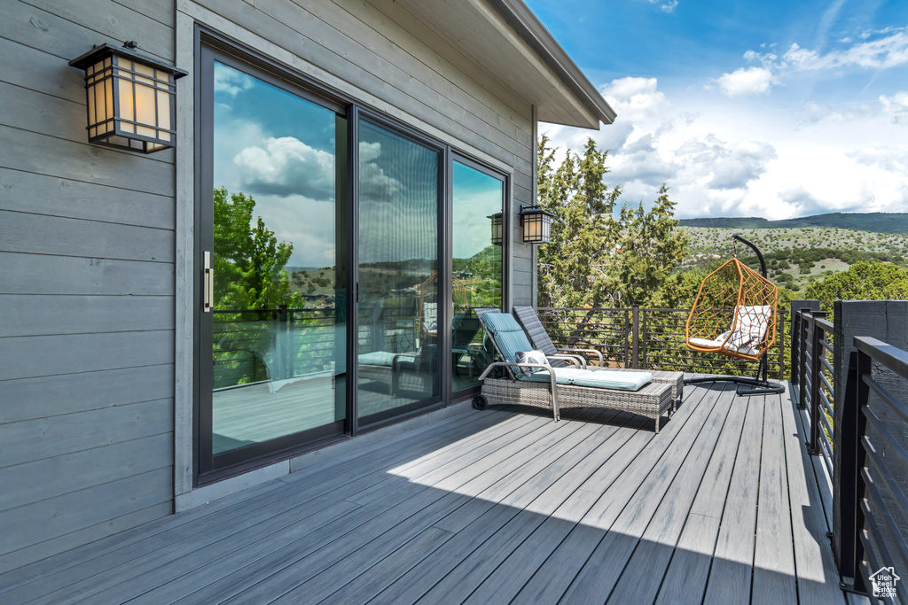 Wooden terrace featuring a mountain view