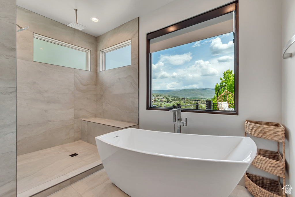 Full bathroom with a freestanding bath, a tile shower, tile patterned flooring, and recessed lighting