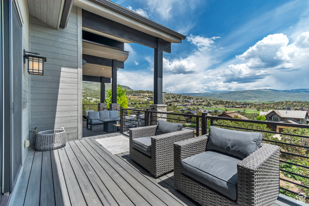 Deck with a mountain view and an outdoor living space