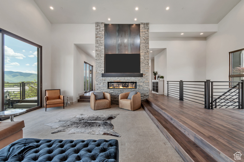 Living area featuring recessed lighting, a fireplace, a mountain view, and wood finished floors