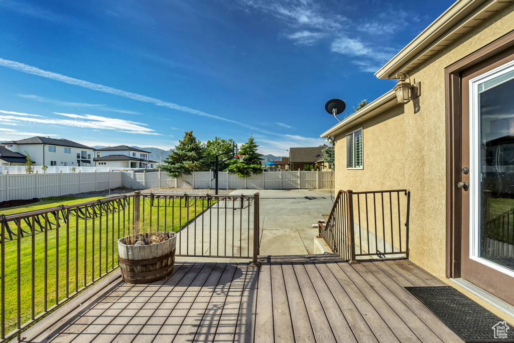 Deck featuring a patio area and a residential view