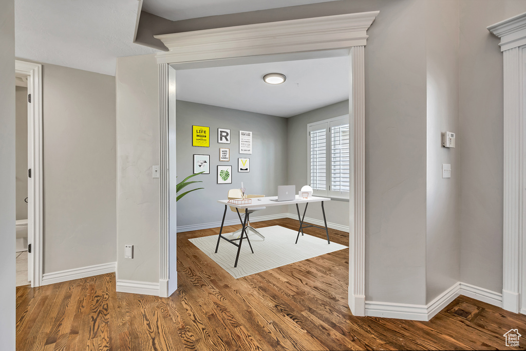 Office with wood finished floors and baseboards