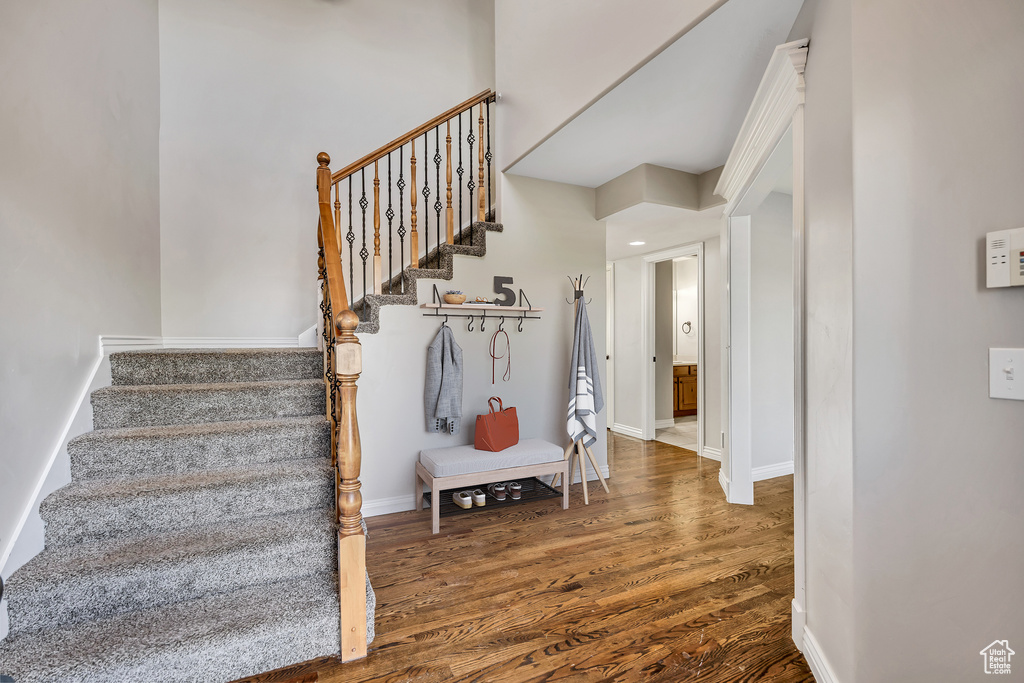 Staircase featuring wood finished floors and baseboards