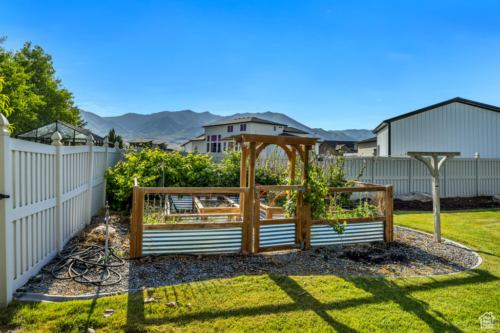 View of yard with a mountain view and a garden