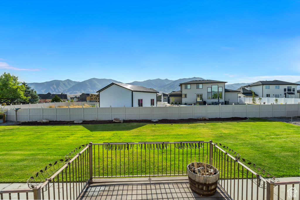 Deck with a residential view and a mountain view