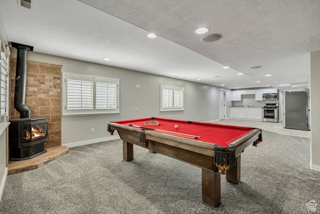 Playroom with light colored carpet, a wood stove, baseboards, billiards table, and recessed lighting