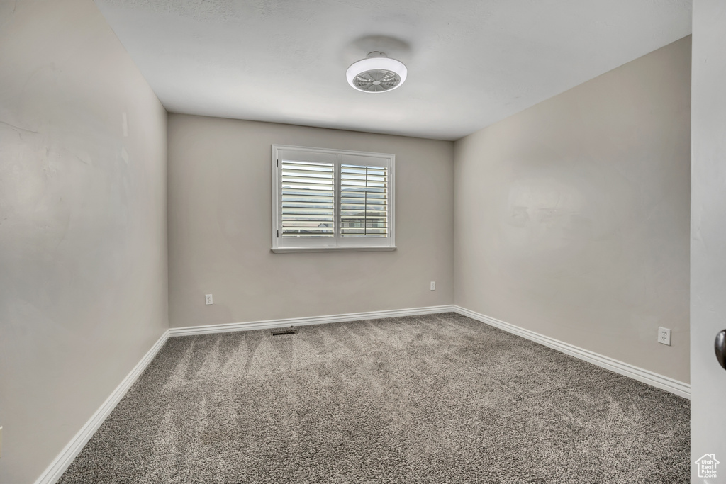 Unfurnished room with carpet and baseboards