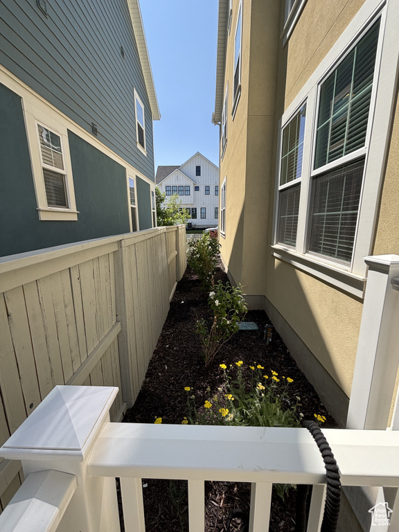 View of side of home with a balcony and stucco siding