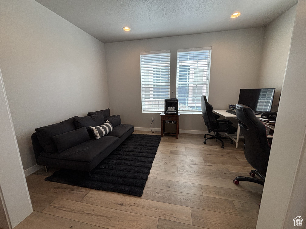 Home office featuring light wood-style floors, recessed lighting, and baseboards