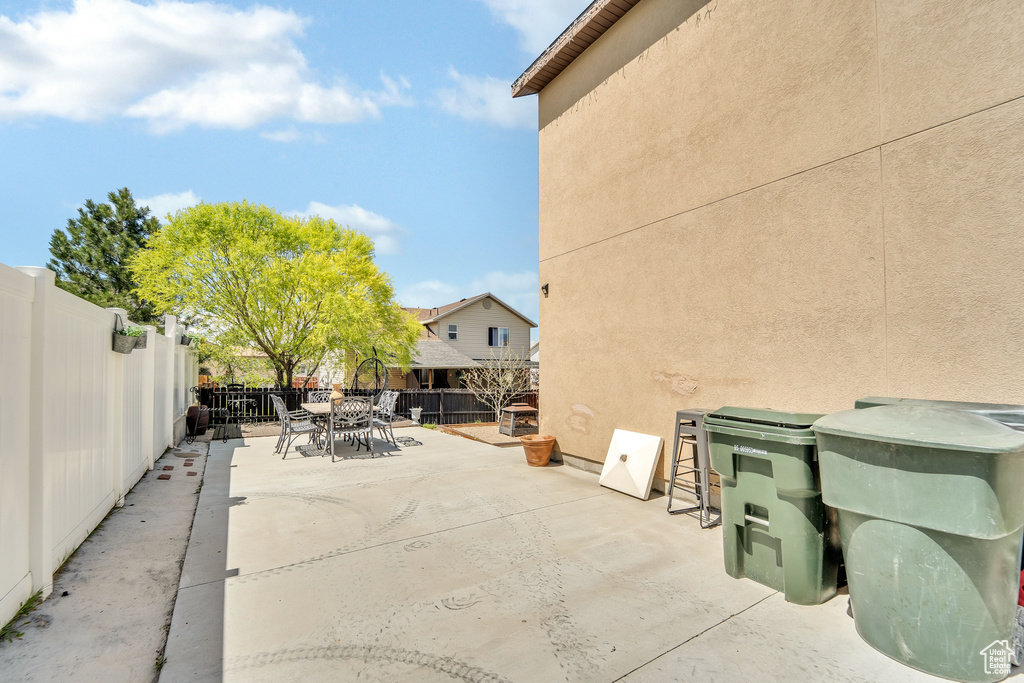 Fenced backyard with outdoor dining space and a patio area