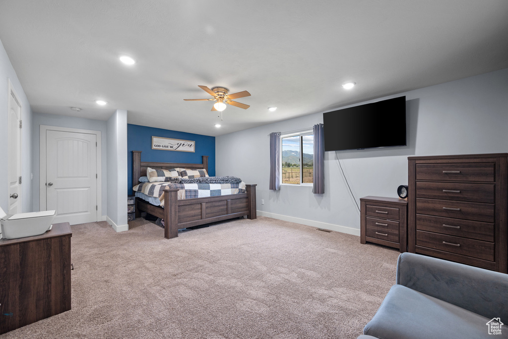 Carpeted bedroom featuring baseboards, recessed lighting, and ceiling fan