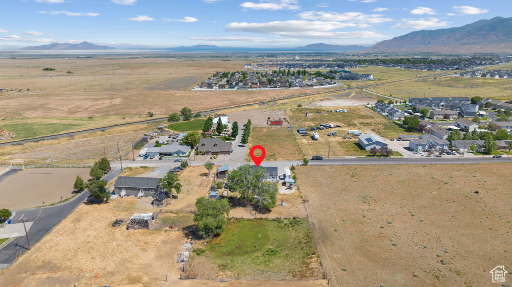 Aerial view of property and surrounding area with mountains and rural landscape