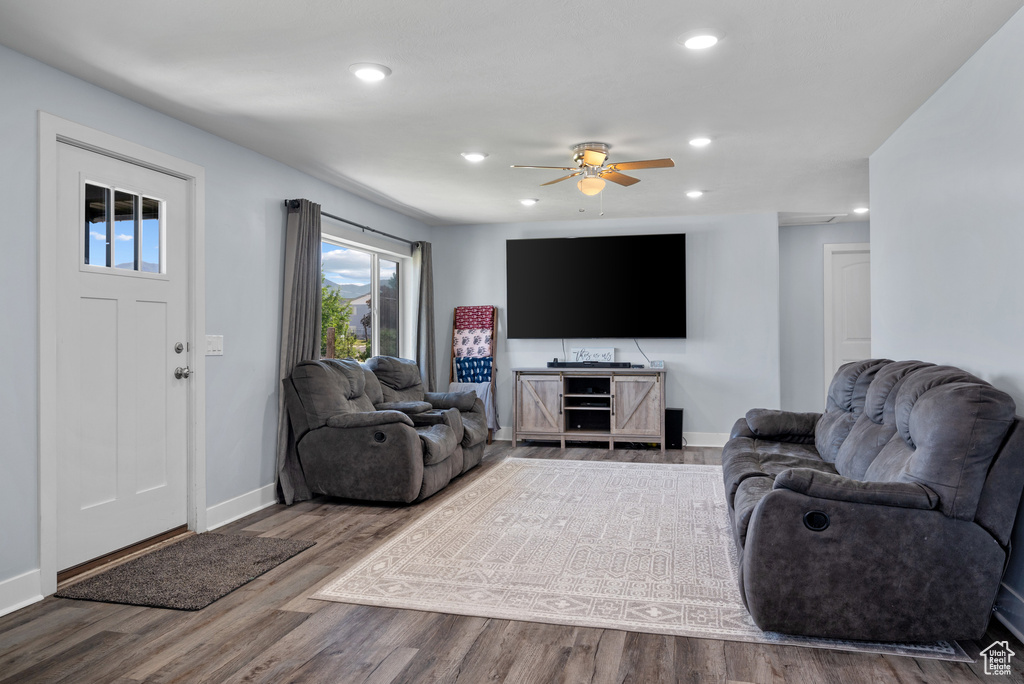 Living room featuring baseboards, recessed lighting, wood finished floors, and ceiling fan